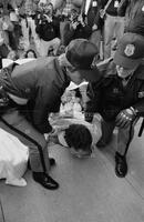 Photograph of a protester being arrested during an AIDS Coalition to Unleash Power demonstration, 1988
