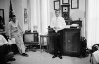 Photograph of Dan Quayle in his office with staff, 1988