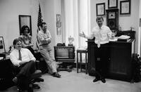 Photograph of Dan Quayle in his office with staff, 1988