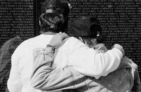 Photograph of two people at the Vietnam Veterans Memorial, 1992