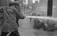 Firemen hosing demonstrators