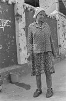 Photograph of a person in front of a destroyed church