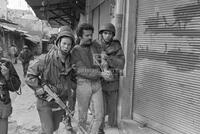 Photograph of a Palestinian man being arrested by Israeli soldiers