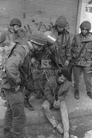 Photograph of a Palestinian man being arrested by Israeli soldiers