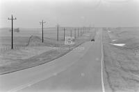 Photograph of a car driving through the Rosebud Reservation