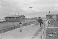 Photograph of a child flying a kite