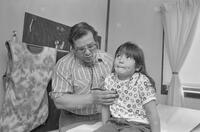 Photograph of a doctor examining a child