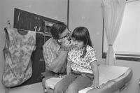 Photograph of a doctor examining a child