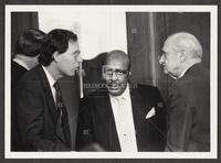 Black and white photograph of Jack Brooks speaking with Louis Stokes and another Representative during the Iran-Contra hearings, 1987