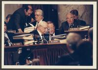 Color photograph of Jack Brooks speaking with another Iran-Contra committee member, 1987