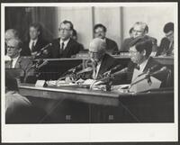 Black and white photograph of Jack Brooks writing during the Iran-Contra trials, 1987