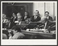 Black and white photograph of Jack Brooks and other representatives during the Iran-Contra trials, 1987
