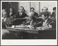 Black and white photograph of Jack Brooks taking notes during the Iran-Contra trials, 1987