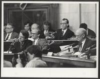 Black and white photograph of Jack Brooks reading documents during the Iran-Contra trials, 1987