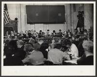 Black and white photograph of people at front of courtroom during the Iran-Contra trials, 1987