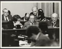 Black and white photograph of representatives and Jack Brooks during the Iran-Contra trials, 1987