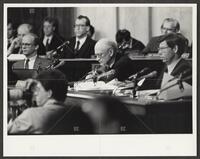 Black and white photograph of Jack Brooks examining a document during the Iran-Contra trials, 1987