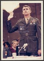 Color photograph of Lt. Col. Oliver North taking an oath during the Iran-Contra trials, July 1987