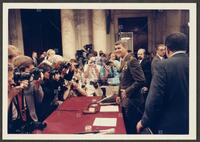 Color photograph of the press speaking with Lt. Col. Oliver North during the Iran-Contra trials, July 1987