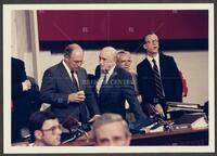 Color photograph of Jack Brooks speaking with a fellow representative during the Iran-Contra trials, July 1987