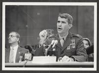 Black and white photograph of Lt. Col. Oliver North talking during the Iran-Contra trials, July 14, 1987