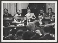 Black and white photograph of Jack Brooks drinking water during the Iran-Contra trials, July 14, 1987