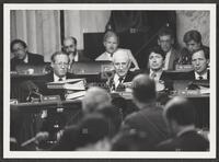 Black and white photograph of Jack Brooks talking and watching the camera during the Iran-Contra trials, July 14, 1987