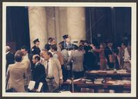 Color photograph from afar of Jack Brooks talking to the press during the Iran-Contra trials, July 14, 1987