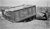Photograph of Backside View of a Damaged Vehicle Lying on a Road
