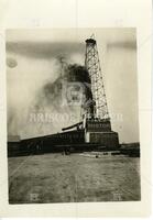 [Oil derrick with gusher]