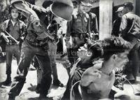Vietnamese soldier threatens Viet Cong prisoner