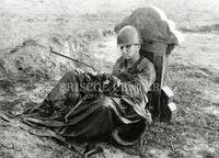 U.S. Marine resting against gravestone