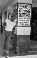 Young man on street corner, Rockdale, August 1951