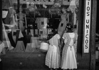 Two women at store window