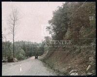 Automobile on a dirt road surrounded by forest,Tennessee, circa 1925
