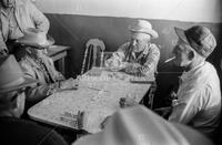 Men playing dominoes; Faces of Texas