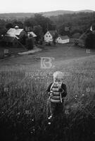 Boy Smelling Flowers