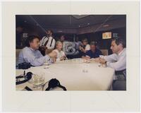 White House photographer Bob McNeely (far left) playing cards with President Bill Clinton and others