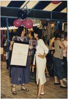 Women talking and holding a nuclear protest sign